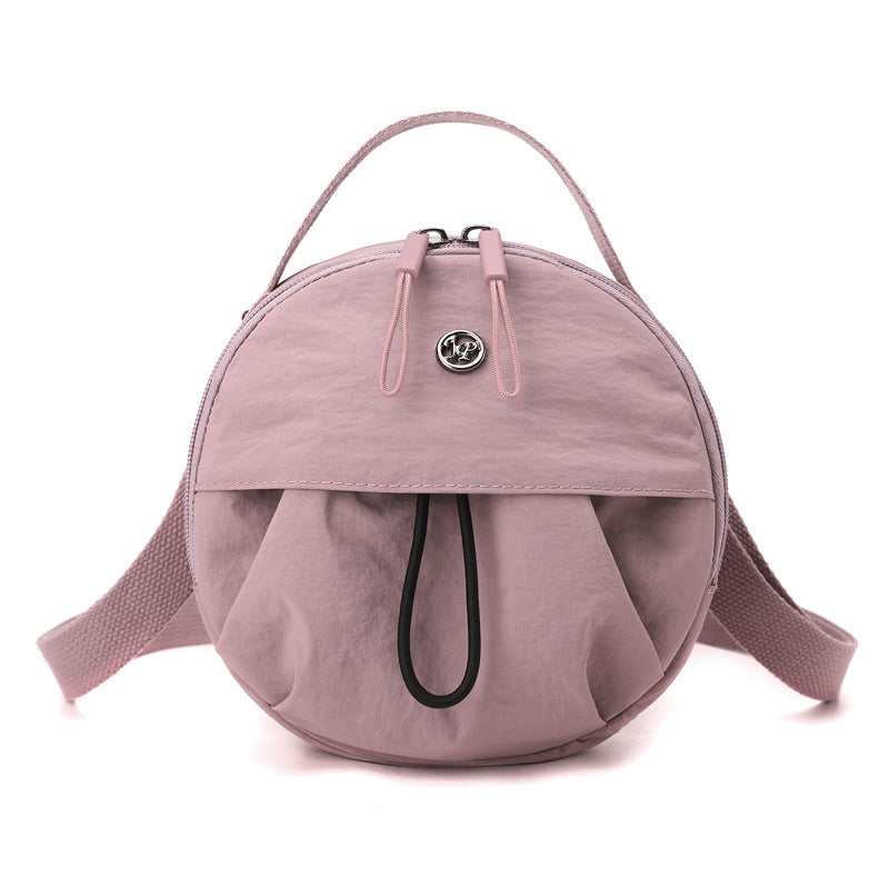 Crayon pink Fashionable Round Crossbody Bag with Water-Resistant Nylon and Multi-Pocket Design for Daily Travel Lightweight Hands-Free Storage Solution for Local Professionals